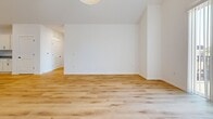 This expansive 2,350 square foot apartment offers a blend of comfort and contemporary design across two well-appointed floors. The lower level, encompassing 1,100 square feet, houses the main living areas. The kitchen showcases modern white cabinetry, stainless steel appliances, and a practical island with a granite countertop. Adjacent, the open-concept living and dining area provides a seamless flow for entertaining.

The upper floor, spanning 1,260 square feet, accommodates two bedrooms, including a generous 150 square foot primary suite. Both floors feature pristine hardwood flooring throughout, enhancing the apartment's aesthetic appeal. The two full bathrooms are equipped with modern fixtures and ample storage.

Natural light floods the space through large windows, some offering picturesque outdoor views. The apartment includes a dedicated laundry room with full-sized washer and dryer units. High ceilings contribute to the overall sense of spaciousness, while the neutral color palette provides a versatile backdrop for various decor styles.

Located in Unit #209 of Building SF1 at 700 W Capitol Dr, Hartland, WI, this apartment combines urban convenience with suburban tranquility. The thoughtful layout, quality finishes, and generous proportions make this an ideal residence for those seeking a contemporary living space with room to grow.
