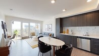Located at 5750 Hollywood Blvd in the heart of Los Angeles, this contemporary single-floor residence offers a well-designed open-concept layout that seamlessly integrates the living, dining, and kitchen areas. The living room is bathed in natural light through floor-to-ceiling sliding glass doors that open onto a private balcony, offering views of the surrounding Hollywood cityscape. The kitchen is outfitted with dark wood cabinetry, a marble-style backsplash, stainless steel appliances including a gas range and French door refrigerator, and clean white countertops — a functional yet stylish space suited for everyday cooking. The dining area sits adjacent to the kitchen, providing a natural flow for entertaining. The bedroom is a calm, well-proportioned retreat featuring a closet, natural light from a dedicated window, and warm neutral tones throughout. The bathroom is finished with light wood-grain flooring, a white vanity with ample storage, and a backlit mirror that adds a modern, polished touch. Wide-plank flooring runs throughout the main living areas, tying the space together with a cohesive, contemporary aesthetic. The overall design balances modern finishes with a warm, livable atmosphere, ideally situated in one of Los Angeles' most iconic neighborhoods.