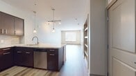 This contemporary 660 square foot apartment in the heart of San Diego offers a perfect blend of style and functionality. The open-concept design maximizes the use of space, creating a seamless flow between the living areas. The kitchen is a standout feature, boasting dark wood cabinetry, stainless steel appliances, and a sleek granite countertop with a breakfast bar, ideal for casual dining or entertaining.

The living room is spacious and bright, with large windows that allow ample natural light to flood the space. Beautiful hardwood flooring runs throughout the apartment, adding warmth and sophistication. The bedroom, measuring 120 square feet, provides a cozy retreat with a ceiling fan for comfort and windows offering city views.

The bathroom is modern and well-appointed, featuring a large vanity with ample storage, and a combination shower/tub. Additional amenities include a closet for storage and in-unit laundry facilities. The apartment's neutral color palette provides a blank canvas for personal styling, while the overall design exudes a contemporary urban aesthetic perfect for those seeking a turnkey living solution in downtown San Diego.