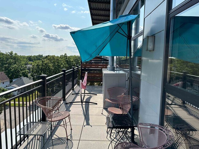 Balcony is full length of the unit, room for seating, grill, hammock and more! - 1701 Madison St NE