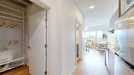 Located at 315 E 2nd Ave in Vancouver's vibrant Mount Pleasant neighbourhood, this thoughtfully designed studio offers an efficient single-floor layout that maximizes every square foot. Light hardwood flooring runs throughout, creating a warm and cohesive aesthetic that ties the space together seamlessly.

The main living area is bathed in natural light courtesy of a large sliding window that frames sweeping views of the surrounding cityscape and distant mountains — a standout feature of the space. The open layout comfortably accommodates both a sleeping and living zone, offering flexibility in how the room is arranged.

The galley-style kitchen is a functional highlight, featuring grey flat-front cabinetry, white quartz countertops, stainless steel appliances including a full-sized range and dishwasher, and a bold yellow subway tile backsplash that adds a lively pop of colour. Recessed lighting overhead keeps the kitchen well-illuminated.

The bathroom is clean and minimalist in design, finished with large-format light tiles, a floating grey vanity with a white countertop, and a practical, accessible layout. A dedicated closet provides convenient built-in storage. The bright white walls and recessed lighting throughout the unit contribute to a fresh, airy ambiance ideal for modern urban living.