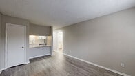 Located at 2716 Buford Hwy in Atlanta, GA, this one-bedroom, two-bathroom unit offers a thoughtfully designed single-floor layout that maximizes every inch of its compact footprint. The open-concept living, dining, and kitchen area creates a seamless flow, anchored by durable wood-style plank flooring and neutral warm-gray walls that lend a clean, modern aesthetic throughout.

The kitchen is a standout feature, boasting white shaker cabinetry, a subway tile backsplash, granite countertops with a breakfast bar overhang, and a full suite of stainless steel appliances including a gas range, dishwasher, and refrigerator. A pantry provides additional storage convenience.

The bedroom is carpeted for comfort, features a window with natural light and a wall-unit air conditioner, and offers access to ample closet space across three closets. Both bathrooms are finished with granite-topped white vanities and subway tile tub surrounds, maintaining a consistent, updated aesthetic. Textured ceilings are present throughout the unit. The space also includes a private entry door, rounding out a functional and well-appointed layout ideal for urban living in Atlanta.