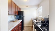 Located at 5613 Crenshaw Rd in Richmond, VA, this two-story, 2-bedroom, 1-bathroom home is thoughtfully laid out across two floors of comparable size. The main level features a combined living and dining area with smooth hardwood-style flooring, a ceiling fan, and a sliding glass door that floods the space with natural light and provides outdoor views. The galley-style kitchen is well-appointed with rich dark wood cabinetry, granite-style countertops, black appliances including a gas range and full-size refrigerator, and a window that brings in additional natural light. The main level also includes closet storage and staircase access to the upper floor. Upstairs, two carpeted bedrooms offer comfortable retreats, each with natural light from windows fitted with blinds. The primary bedroom is a generous size and includes ceiling fan with light fixture. The second bedroom is equally bright and airy. Three closets are distributed throughout the home, providing ample storage. The full bathroom features a tub-shower combination with clean white surroundings. A hallway connects the upstairs rooms, completing a practical and efficient floor plan suitable for everyday living.