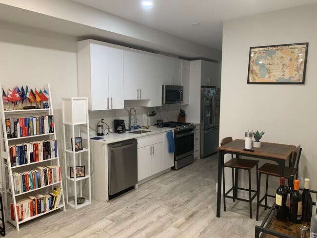 Kitchen with high top table and brand new appliances. - 2556 University Pl NW