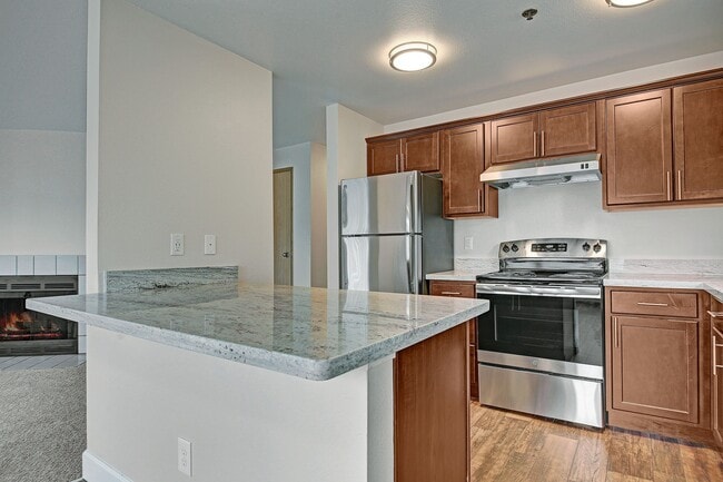 Kitchen with stainless steel appliances, ample counter space and lots of cabinet storage - Foster Greens
