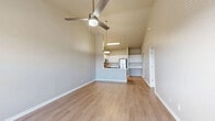 Located at 5382 E 81st St in Tulsa, Oklahoma, this one-bedroom, one-bathroom unit offers a thoughtfully designed layout that maximizes its efficient footprint. The open-concept main living area seamlessly integrates the living room, dining space, and kitchen under soaring vaulted ceilings, creating an airy and spacious feel. Light wood-style flooring runs throughout the main living areas, while a ceiling fan adds both style and function.

The kitchen is a standout feature, equipped with stainless steel appliances including a refrigerator, range, and microwave. Two-tone cabinetry — white uppers and gray lowers — is paired with light quartz countertops and a peninsula with a sink, offering additional prep space and a natural divide from the living area. A built-in shelving nook adjacent to the kitchen provides extra storage or display space.

The bedroom is a comfortable retreat, finished with plush carpeting, a ceiling fan, and a window with blinds that allows natural light. A dedicated closet offers practical storage. The full bathroom features a soaking tub and shower combination, white cabinetry, a single vanity with a light countertop, and matching light flooring. An in-unit laundry area adds everyday convenience to this well-appointed home.