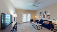 Located at 5746 Leila Ln in Westerville, Ohio, this single-floor residence offers a thoughtfully designed layout with a comfortable blend of functionality and style. The living room is a welcoming space featuring plush carpet, a ceiling fan, and French doors that invite natural light and provide outdoor views. The kitchen is outfitted with dark espresso cabinetry, stainless steel appliances including a refrigerator, range, and microwave, and durable hardwood-style flooring that extends into the adjacent dining area. The dining nook is an intimate space highlighted by a pendant light fixture, ideal for everyday meals. The bedroom is generously sized with soft carpet, large windows offering exterior views, and direct access to a spacious walk-in closet. Two full bathrooms are finished with dark vanity cabinetry, light countertops, hardwood-style flooring, and tub-shower combinations. A dedicated in-unit laundry area accommodates a full-size washer and dryer side by side. Warm neutral tones carry throughout the residence, creating a cohesive and inviting atmosphere. The overall layout is efficient and practical, making this Westerville residence a well-rounded living space.