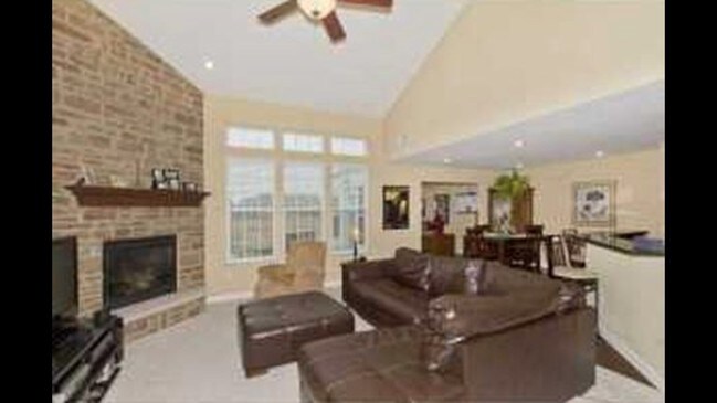Gas fireplace with floor to ceiling stone - 5110 Dinard Way