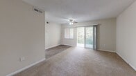 Located at 880 Glendale Dr in Cary, NC, this single-floor residence offers a well-organized and functional layout. The kitchen is outfitted with white cabinetry, light granite-style countertops, a double sink, and black appliances including a range, over-the-range microwave, and refrigerator, all set above warm hardwood-style flooring. The living area is generously sized, featuring plush carpeting, a ceiling fan with light fixture, and a sliding glass door that opens to a private balcony overlooking lush, tree-lined surroundings, bringing abundant natural light into the space. The bedrooms are comfortable and well-proportioned, each with soft carpeting, windows with views of the surrounding greenery, and good closet space, including a dedicated closet with a hanging rod in at least one bedroom. The layout also reveals access to a bathroom with an attached private entry, featuring a full-size soaking tub and shower combo with built-in wall niches. Neutral, warm-toned walls throughout the residence create a clean and inviting atmosphere. Textured ceilings and consistent trim work add to the cohesive design. The overall layout is practical and efficiently planned, making the most of the available space on a single level.