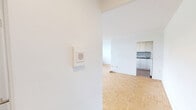 Located on the third floor at 263 Dixon Road in Toronto, this well-laid-out two-bedroom, one-bathroom unit offers a comfortable and functional living space. Warm parquet flooring runs consistently throughout the main living areas and bedrooms, giving the home a cohesive and classic character.

The open living room is generously sized, bathed in natural light through large windows that frame views of the surrounding greenery and neighbouring buildings. A baseboard heating system lines the window walls, ensuring year-round comfort. The kitchen is accessed via a dedicated passageway from the living room and features white cabinetry, a subway tile backsplash, a white electric range, and durable tile flooring — a practical and tidy workspace.

The primary bedroom is notably spacious and includes a walk-in closet with built-in shelving, offering excellent storage. The second bedroom is a comfortable size, also with parquet flooring and a bright window with outdoor views. A hallway connects all rooms efficiently, contributing to the unit's logical and easy-to-navigate layout.

The bathroom is finished with clean white subway tile surrounding a full soaker tub with overhead shower, maintaining a bright and functional aesthetic throughout. Overall, the unit presents a clean, neutral palette ideal for a variety of living arrangements.