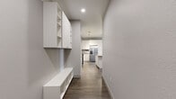 Located at 1805 S Bannock St in Denver's vibrant South Broadway neighborhood, this well-appointed one-bedroom, one-bathroom residence offers a thoughtfully designed single-floor layout with modern finishes throughout. Wood-look plank flooring runs consistently across every room, creating a cohesive and contemporary aesthetic.

The open-concept kitchen and living area serves as the heart of the home. The kitchen is a standout feature, showcasing white shaker-style cabinetry extending to the ceiling, a gray subway tile backsplash, quartz countertops, stainless steel appliances including a French door refrigerator, range, microwave, and dishwasher, as well as a central island that provides additional prep space and casual seating. Pendant and track lighting add a polished touch overhead.

The living area is bright and welcoming, featuring a ceiling fan, windows with blinds, and a glass door that invites natural light and outdoor access. The spacious bedroom also includes a ceiling fan and a generous window with outdoor views, providing a comfortable, airy retreat. A dedicated walk-in closet offers ample storage with dual hanging rods and shelving.

The bathroom is clean and modern, featuring white cabinetry, a framed vanity mirror, dark countertops, and a glass-enclosed shower with white tile surround.