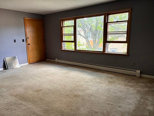 Large living room overlooking a beautifully landscaped courtyard. - 3515 S Harlem Ave