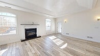 Located at 220 Adams Pointe Blvd N in Mars, PA, this well-appointed 2-bedroom, 2-bathroom home offers a thoughtfully designed single-floor layout. The bright and airy living room is a standout feature, showcasing a tray ceiling, a classic white-mantled gas fireplace with a dark hearth, and wood-look tile flooring that flows throughout the main living areas. Large arched windows flood the space with natural light and offer pleasant views of the surrounding community. The open kitchen is outfitted with white cabinetry, dark granite countertops, and black stainless appliances, including a gas range, built-in microwave, and refrigerator. A dedicated laundry room with a full-size washer and dryer adds everyday convenience. Both bedrooms feature plush carpet, ceiling fans, and ample natural light, with the primary bedroom offering generous proportions. The two bathrooms are finished with light tile flooring, white vanities with dark granite countertops, gold hardware accents, and a tub/shower combo with sliding glass doors. A private balcony overlooks the well-maintained community, framed by seasonal foliage and clear skies, providing a peaceful outdoor retreat.