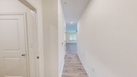 Located at 109 Capstone Way in Commerce, GA, this single-floor, two-bedroom, two-bathroom home offers a clean, modern design with a bright and cohesive aesthetic throughout. Light wood-look flooring runs continuously across the living areas, bedrooms, and hallway, lending a sense of warmth and continuity to the space.

The kitchen is well-appointed with rich wood cabinetry, granite countertops, a kitchen island, and a full suite of stainless steel appliances including a refrigerator, range, microwave, and dishwasher. Recessed lighting and a window provide both functional and natural illumination.

The living room is open and airy, benefiting from multiple windows fitted with blinds that allow for ample natural light. The primary bedroom is a comfortable size, complete with a ceiling fan and a window with outdoor views. The second bedroom is similarly bright with its own ceiling fan.

Both bathrooms are finished with granite-topped vanities and wood cabinetry. One bathroom features a tub-shower combination with built-in shelving, a large mirror, and elegant brushed nickel fixtures. A dedicated laundry room houses a full-size washer and dryer with overhead shelving. A central hallway connects all rooms efficiently, completing this well-organized and move-in-ready home.