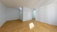 Located at 5505 Boul Cavendish in Côte-Saint-Luc, this well-laid-out 2-bedroom, 2-bathroom residence offers a functional and bright living environment across a single floor. The interior is characterized by classic parquet wood flooring that runs throughout the main living areas and bedrooms, lending warmth and a timeless aesthetic to the space.

The combined dining and living room is generously proportioned, bathed in natural light through large sliding windows equipped with baseboard heating beneath them. The bright, white walls and textured ceilings contribute to an airy, open feel.

The galley-style kitchen features white cabinetry, a marble-patterned countertop with a stainless steel sink, a white electric range, and ample upper storage. Tile flooring and an overhead range hood complete the practical layout, with a pass-through to the main hallway.

The spacious primary bedroom offers room for substantial furnishings and includes a closet, while the second bedroom is also well-sized with its own closet and parquet flooring. Both bathrooms are clean and functional, featuring white vanities with marble-style countertops, mirrored medicine cabinets, and tile flooring. Two additional hallway closets provide convenient storage throughout. The unit also benefits from two connecting hallways for smooth circulation.