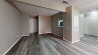 Located at 1428 N Ninth St in Midlothian, TX, this well-appointed one-bedroom, one-bathroom home offers a thoughtfully organized single-floor layout with consistent vinyl plank flooring throughout. The living room serves as the heart of the home, highlighted by a classic tiled fireplace, a ceiling fan with light fixture, and a sliding glass door fitted with vertical blinds that invites natural light into the space. Textured ceilings add a subtle architectural detail found throughout the home. The galley-style kitchen is efficiently designed with white cabinetry featuring brushed nickel hardware, light granite-style countertops, and a full suite of black appliances including a gas range, refrigerator, and dishwasher. The bedroom is a comfortable retreat, offering a ceiling fan, a window with blinds for natural light, and direct access to both the full bathroom and a walk-in closet with built-in shelving. The bathroom is clean and functional, featuring a tub/shower combo with white tile surround, a granite-top vanity, and matching vinyl plank flooring. A dedicated hallway connects the main living spaces, completing this practical and move-in-ready home.