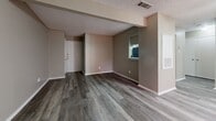Located at 1428 N Ninth St in Midlothian, TX, this well-appointed one-bedroom, one-bathroom home offers a thoughtfully organized single-floor layout with consistent vinyl plank flooring throughout. The living room serves as the heart of the home, highlighted by a classic tiled fireplace, a ceiling fan with light fixture, and a sliding glass door fitted with vertical blinds that invites natural light into the space. Textured ceilings add a subtle architectural detail found throughout the home. The galley-style kitchen is efficiently designed with white cabinetry featuring brushed nickel hardware, light granite-style countertops, and a full suite of black appliances including a gas range, refrigerator, and dishwasher. The bedroom is a comfortable retreat, offering a ceiling fan, a window with blinds for natural light, and direct access to both the full bathroom and a walk-in closet with built-in shelving. The bathroom is clean and functional, featuring a tub/shower combo with white tile surround, a granite-top vanity, and matching vinyl plank flooring. A dedicated hallway connects the main living spaces, completing this practical and move-in-ready home.