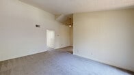 Located in San Marcos, CA, this single-floor home offers four bedrooms and two bathrooms within a thoughtfully arranged floor plan. The living area features soaring vaulted ceilings with a ceiling fan, creating a bright and open atmosphere complemented by soft carpeted floors throughout. Large windows in multiple rooms invite abundant natural light and provide views of the surrounding greenery.

The spacious primary bedroom is particularly notable for its generous proportions and includes mirrored sliding closet doors that enhance the sense of space, along with direct access to an en-suite bathroom. Each additional bedroom is well-sized, carpeted, and equipped with mirrored closet doors and ample wall space.

The kitchen is clean and functional, featuring white cabinetry, speckled quartz-style countertops, a stainless steel double-basin sink with a pull-down faucet, and a dishwasher. A window above the sink allows natural light to fill the space.

Both bathrooms are finished with light wood-look tile flooring, speckled countertops, and white vanities. One bathroom features a full tub-shower combination, while the other offers a toilet and vanity setup. A hallway connects the rooms efficiently, completing this well-organized and functional single-story home.
