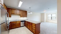This one-bedroom, one-bathroom residence in Shoreview, Minnesota offers a thoughtfully designed single-floor layout with a comfortable and functional living environment. The kitchen is a standout feature, showcasing rich warm-toned cabinetry, granite countertops, and a full suite of stainless steel appliances including a refrigerator, range, microwave, and dishwasher. A peninsula with pendant lighting above provides additional counter space and creates a natural transition into the open living area. The living room is bright and airy, with plush carpeting, neutral walls, and windows that invite natural light and offer pleasant outdoor views. The generously sized bedroom continues the warm, neutral palette with soft carpeting, a ceiling fan with light fixture, and a large window overlooking the surrounding landscape. A dedicated closet off the bedroom features wire shelving and hanging rods for ample storage. A second closet is also present in the bedroom. The bathroom is clean and functional, featuring tile flooring, a wood vanity with a white countertop, and a full soaking tub with shower. The overall ambiance is calm and welcoming, making this Shoreview residence a comfortable and practical living space.