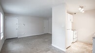 Located at 222 Merrimac Trail in Williamsburg, Virginia, this single-floor residence offers a practical and comfortable layout throughout. The open living area features neutral-toned carpet and connects seamlessly to a kitchen equipped with white cabinetry, stone-look countertops, and tile flooring, creating a functional flow between spaces. The entry area provides direct access to additional rooms, with clean white doors and light-toned walls lending a bright, airy feel throughout. The bedrooms are carpeted and outfitted with ceiling fans featuring integrated lighting, providing comfort year-round. One bedroom notably includes dual reach-in closets, offering generous storage capacity, while another benefits from a window that invites natural light and views of surrounding greenery. The bathroom is finished with classic white subway tile surrounding a soaking tub and shower combination, complemented by tile flooring and chrome fixtures, creating a clean and timeless aesthetic. Throughout the residence, neutral wall tones and consistent flooring choices contribute to a cohesive and understated interior atmosphere, making the space well-suited for easy personalization.