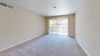 Located at 2366 American River Drive in Sacramento, CA, this single-floor residence features a well-organized layout with two bedrooms, one bathroom, a kitchen, and a combined living area. The living room is a welcoming, open space anchored by a ceiling fan and sliding glass doors that lead to an outdoor area, allowing natural light and garden views to fill the room. The carpet flooring adds warmth and comfort to the living space.

The kitchen is efficiently designed with light wood cabinetry, open shelving, white countertops with a stainless steel sink, hardwood-style flooring, and stainless steel appliances including a full-size refrigerator and range.

Both bedrooms are carpeted and feature ceiling fans with windows that frame leafy outdoor views, creating a calm and airy atmosphere. The primary bedroom offers a generous footprint, closet access, and multiple doorways connecting it to the rest of the home. The second bedroom is equally comfortable with clean walls and natural light.

The bathroom is cleanly appointed with a full tub-shower combination, a toilet, and hardwood-style flooring, reflecting a simple and functional design. Throughout the residence, neutral warm tones, white trim, and textured ceilings create a cohesive and understated aesthetic.