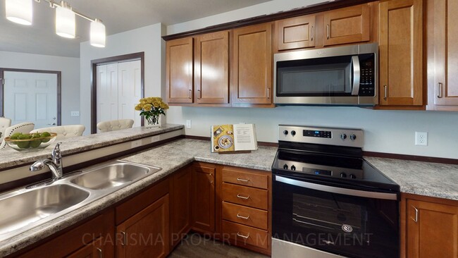 Building Photo - TOWN HOME WITH INDIVIDUAL ENTRANCE, WALK OUT PATIO, ATTACHED DOUBLE GARAGE & PET FRIENDLY