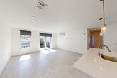 Located at 42 N Beacon Street in Boston's Allston neighborhood, this modern unit offers four bedrooms and two bathrooms across a thoughtfully designed single-floor layout. The open-concept living area is bright and airy, featuring light hardwood-style flooring, recessed lighting, and large windows with roller shades that invite abundant natural light. Sliding glass doors lead to a private balcony, extending the living space outdoors with views of the surrounding neighborhood.

The kitchen is a standout feature, showcasing a generous waterfall-edge island with an integrated sink, sleek white cabinetry, a white subway tile backsplash, stainless steel appliances, and elegant pendant lighting — ideal for both cooking and entertaining.

Each bedroom is well-proportioned and finished with the same light flooring and clean white walls. Individual wall-mounted mini-split units provide climate control in the bedrooms and living areas. The primary bedroom enjoys direct balcony access through sliding glass doors. Several bedrooms offer cityscape views through large windows.

The bathrooms are cleanly appointed with tiled showers, warm wood vanities, and mirrored medicine cabinets. A dedicated laundry area and four closets add practical convenience. The unit also includes a welcoming entrance and hallway, completing a well-organized and modern living space.