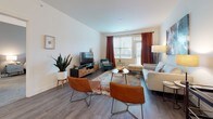 This single-floor residence at 6847 Stewart Rd in Cincinnati, Ohio offers a thoughtfully designed layout with modern finishes throughout. The open-concept kitchen is a standout feature, showcasing two-tone cabinetry with crisp white uppers and rich dark lower cabinets, granite countertops, a classic subway tile backsplash, and a full suite of stainless steel appliances including a range, microwave, dishwasher, and refrigerator. A kitchen island provides additional prep and seating space, all set atop durable wood-style flooring.

The living area is bright and welcoming, with large windows and a glass door that invite natural light and provide views of the outdoors. Wood-style flooring continues throughout, complementing the neutral wall palette and creating a cohesive, airy feel.

The bedrooms are carpeted for comfort and feature accent walls in bold, contemporary colors. Each room offers generous closet space, including walk-in options, and windows that allow for natural light. The primary bedroom includes a ceiling fan and an en-suite bathroom with a walk-in shower, while a second full bathroom features a soaking tub and shower combination. The overall ambiance is modern, clean, and move-in ready.