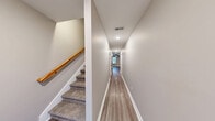 Located at 580 Heritage Pointe Dr in Clarksville, TN, this two-story home offers 3 bedrooms and 3 bathrooms across two well-organized floors. The main level hosts the combined kitchen and living area, a garage, and a staircase leading to the upper level. The kitchen is outfitted with white shaker-style cabinetry, granite countertops, stainless steel appliances including a range, over-the-range microwave, dishwasher, and refrigerator, all set over durable wood-look flooring. The living room continues the same flooring and features a ceiling fan and natural light from multiple windows. The upper level holds all three bedrooms, including a generously sized primary bedroom, each carpeted and equipped with ceiling fans and windows that bring in natural light. The three bathrooms are finished with granite-topped vanities and oil-rubbed bronze fixtures, with at least one featuring a full tub-shower combo. A dedicated hallway and closet provide additional storage and organization. The attached garage offers a clean, functional space with an automatic opener. Neutral tones, clean lines, and consistent finishes create a cohesive and move-in-ready environment throughout the home.