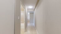Located at 544 Birchmount Road in Toronto's Scarborough area, this one-bedroom, one-bathroom unit offers a well-organized layout across a single floor, making efficient use of every square foot.

The kitchen serves as a functional centrepiece, featuring warm wood cabinetry, a marble-style peninsula countertop with an integrated sink, and white appliances including an electric range and refrigerator. Light-toned tile flooring grounds the space, while the peninsula design creates a natural division between the kitchen and the adjacent living area, which features light laminate hardwood flooring.

The bedroom is a calm, understated retreat finished in neutral tones with light laminate flooring. A large window allows natural light to filter in and offers a view of surrounding greenery. A baseboard heating unit runs along the exterior wall, ensuring comfort year-round. Built-in sliding double closet doors provide practical storage without compromising the room's clean aesthetic.

The bathroom is finished with warm beige wall tiles surrounding a full soaker bathtub and shower combination, complemented by chrome fixtures and a classic white toilet.

A hallway connects the rooms, contributing to the unit's straightforward and accessible flow. Overall, the space presents a clean, neutral palette with practical finishes suited to comfortable everyday living.