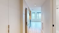Located in Montréal's Old Port neighbourhood, this 1-bedroom, 1-bathroom unit at 997 De La Commune offers a thoughtfully designed open-concept layout with clean, modern finishes throughout. Light hardwood flooring flows seamlessly across the living, dining, and kitchen areas, creating a bright and cohesive feel.

The kitchen is well-appointed with stainless steel appliances — including a refrigerator, electric range, built-in microwave, and dishwasher — complemented by light wood upper cabinetry, white lower cabinets, a white subway tile backsplash, and ample storage. A globe pendant light and track lighting add functional style to the space.

The living area is bathed in natural light from large windows that frame impressive views of the Montréal skyline and waterfront. The bedroom offers a cozy, private retreat with its own closet and tall windows that continue the expansive city and green space views.

The bathroom features a clean, spa-inspired design with large-format grey floor tiles, a deep soaking tub with shower, a floating wood-tone vanity with an integrated white sink, and a mirrored medicine cabinet. The overall ambiance of the unit is bright, contemporary, and efficiently designed.