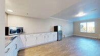 Located at 2886 S Circle Dr in Colorado Springs, CO, this well-appointed one-bedroom, two-bathroom unit offers a thoughtfully designed single-floor layout. Light-toned wood-look flooring flows consistently throughout the space, complemented by crown molding that adds a refined touch to every room.

The open kitchen features an expansive run of white shaker-style cabinetry topped with granite countertops, a tile backsplash, a stainless steel refrigerator, and recessed lighting — providing ample prep and storage space. The living area is generously sized, bathed in natural light from multiple windows adorned with white blinds that frame views of surrounding greenery. Wall-mounted HVAC units ensure year-round comfort.

The spacious primary bedroom offers a bright, open atmosphere with large windows and a built-in granite-topped vanity nook with gold-framed mirror and wall sconces. The two bathrooms are well-appointed: one features a dual-sink vanity with granite countertops, white cabinetry, gold-framed mirrors, and recessed lighting, while the second includes a tub/shower combination with elegant marble-style tile surround. The overall aesthetic is clean, modern, and move-in ready.