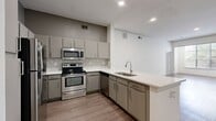 Located on the iconic South Congress Avenue in Austin, TX, this single-story, 4-bedroom, 2-bathroom home offers a well-designed layout across a generously sized floor plan. Wood-look flooring flows consistently throughout, lending a cohesive and modern aesthetic to every room.

The open-concept kitchen and living area serves as the heart of the home. The kitchen is equipped with stainless steel appliances — including a range, microwave, and dishwasher — complemented by gray cabinetry, a mosaic tile backsplash, quartz countertops, and a peninsula with an undermount sink. A graceful arched passageway connects the kitchen to the bright living room, which features a classic white-mantled fireplace and a large window that fills the space with natural light.

The spacious primary bedroom includes vaulted ceilings, a ceiling fan, and French doors that invite additional light. Walk-in closets provide ample storage throughout the home. The bathrooms are finished with clean, contemporary gray vanities and light wood-look tile flooring. A dedicated laundry room houses a full-size washer and dryer with additional shelving for storage.

With four well-proportioned bedrooms and a functional, open layout, this home is ideally situated in one of Austin's most vibrant and walkable neighborhoods.