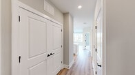 Located at 901 St Albans Dr in Raleigh, NC, this well-appointed 2-bedroom, 2-bathroom residence offers a thoughtfully designed single-floor layout with a clean, contemporary aesthetic. Warm-toned luxury vinyl plank flooring runs throughout the main living areas and hallways, complemented by neutral gray-beige walls and crisp white trim.

The kitchen is a standout feature, showcasing white shaker cabinetry, quartz countertops, a classic subway tile backsplash, and stainless steel appliances including a refrigerator, range, microwave, and dishwasher. A central island with pendant lighting adds both functionality and style, while recessed lighting enhances the bright, open atmosphere shared with the living area.

The primary bedroom is a comfortable retreat with plush carpeting, a ceiling fan, and a large window overlooking the surrounding neighborhood. It connects directly to a spacious en-suite bathroom featuring a double vanity with white cabinetry, a framed mirror, wood-look flooring, and a glass-enclosed walk-in shower with marble-style tile. The second bedroom also features carpeted floors, a ceiling fan, and ample natural light. The second full bathroom offers a tub-shower combination with elegant marble-style tile surround and a white vanity. Two hallways and two closets round out the efficient, well-organized floor plan.