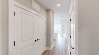 Located at 901 St Albans Dr in Raleigh, NC, this well-appointed 2-bedroom, 2-bathroom residence offers a thoughtfully designed single-floor layout with a clean, contemporary aesthetic. Warm-toned luxury vinyl plank flooring runs throughout the main living areas and hallways, complemented by neutral gray-beige walls and crisp white trim.

The kitchen is a standout feature, showcasing white shaker cabinetry, quartz countertops, a classic subway tile backsplash, and stainless steel appliances including a refrigerator, range, microwave, and dishwasher. A central island with pendant lighting adds both functionality and style, while recessed lighting enhances the bright, open atmosphere shared with the living area.

The primary bedroom is a comfortable retreat with plush carpeting, a ceiling fan, and a large window overlooking the surrounding neighborhood. It connects directly to a spacious en-suite bathroom featuring a double vanity with white cabinetry, a framed mirror, wood-look flooring, and a glass-enclosed walk-in shower with marble-style tile. The second bedroom also features carpeted floors, a ceiling fan, and ample natural light. The second full bathroom offers a tub-shower combination with elegant marble-style tile surround and a white vanity. Two hallways and two closets round out the efficient, well-organized floor plan.