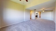Located at 701 Harrison St in Allentown, PA, this single-floor residence offers three bedrooms, two bathrooms, and a practical hallway connecting the living spaces. The layout, visible in the dollhouse view, flows from a kitchen equipped with stainless steel appliances into an open living area featuring dual ceiling fans and generous wall space.

The spacious primary bedroom is a standout feature, highlighted by a wide multi-panel window that frames outdoor city views and is complemented by a ceiling fan overhead and plush carpeting underfoot. The two additional bedrooms are well-proportioned, each offering closets with sliding or paneled doors and soft carpet flooring, with one bedroom benefiting from a wide window wall that floods the room with natural light and sweeping views.

Both bathrooms are clean and functional. One full bath features wood-look vinyl flooring, a white vanity with a single sink, and a tub/shower combo. The second bathroom doubles as a laundry room, accommodating a full-size washer and dryer alongside a vanity with a mirrored medicine cabinet and built-in shelving above the units.

Throughout, neutral warm-toned walls, white trim, and carpeted floors create a cohesive, move-in ready aesthetic. The abundance of windows across multiple rooms ensures consistent natural light and views of the surrounding Allentown neighborhood.