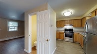Located at 105 Foxcroft Dr in Scarborough, Maine, this two-floor home offers a practical and well-organized layout across both levels. The main floor features an open living area with smooth hardwood-style flooring in a cool grey tone, warm neutral-painted walls, and a bright window that invites natural light. A staircase with a white-painted banister connects the floors, adding a clean, classic architectural element to the space.

The kitchen is efficiently designed with warm oak cabinetry, light countertops, and a full suite of stainless steel appliances including a range, refrigerator, and dishwasher. A door off the kitchen provides convenient exterior access. Adjacent to the kitchen is a half bath, offering added functionality on the main level.

The upper floor hosts multiple bedrooms, each finished with plush carpeting, baseboard heating, and windows that bring in natural light. The bedrooms are generously proportioned and include closets with built-in shelving, providing ample storage. A full bathroom on this level features a single vanity with oak cabinetry, a tub-shower combination, a window for ventilation, and baseboard heating. The home's consistent neutral palette and practical finishes throughout create a comfortable and move-in-ready living environment.