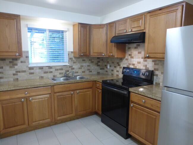 Window above the sink makes a cheery kitchen. - 20842 1st Ave S