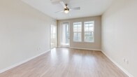 Located at 375 Summer Cypress Cove in Longwood, FL, this well-appointed 3-bedroom, 2-bathroom single-story home offers a bright and modern living experience. The open-concept kitchen and living area serves as the heart of the home, featuring crisp white shaker cabinetry, quartz countertops, a large center island with pendant lighting, subway tile backsplash, and a full suite of stainless steel appliances. Light wood-look flooring flows throughout the main living areas, enhancing the airy, clean aesthetic. The living room is bathed in natural light from large windows and is equipped with a ceiling fan for comfort. The three bedrooms are carpeted and generously sized, with the primary bedroom offering ample space and dedicated closet storage. Four closets throughout the home provide excellent organizational capacity. The two bathrooms are finished with white cabinetry, quartz vanities, and wood-look tile flooring, with one featuring a full tub-shower combination. A dedicated laundry room with side-by-side washer and dryer adds everyday convenience. The private balcony overlooks lush greenery and the surrounding community, offering a relaxing outdoor retreat beneath Florida's open skies.