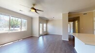 Located at 355 W Burgundy St in Highlands Ranch, Colorado, this single-floor residence offers a thoughtfully designed layout with a blend of comfort and modern finishes throughout.

The open living area is a welcoming centerpiece, featuring rich hardwood-style flooring, crown molding, and a ceiling fan with light fixture. Large windows allow generous natural light to fill the space, enhancing its airy and open feel. An adjacent kitchen is well-appointed with warm wood-toned cabinetry, a tiled backsplash, stainless steel appliances including a refrigerator, electric range, and microwave, as well as light-colored countertops and a deep single-basin sink. A breakfast bar-style counter connects the kitchen to the main living space, making it ideal for casual dining or entertaining.

The bedrooms feature plush carpeting and ample closet storage, including a walk-in style closet in one room. A sliding glass door in one of the bedrooms opens to a private balcony with outdoor views, adding an inviting extension to the living space. The bathroom is clean and functional, complete with a full soaking tub, white subway tile surround, and hardwood-style flooring. Crown molding and neutral tones throughout contribute to a cohesive and polished overall aesthetic.
