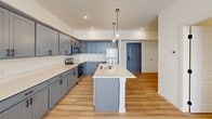 Located at 4000 Emerson Dr in Mount Wolf, PA, this well-appointed one-bedroom, one-bathroom residence offers a thoughtfully designed single-floor layout that maximizes comfort and functionality. The open-concept living and kitchen area serves as the heart of the home, anchored by a striking kitchen island with a double-basin sink and crisp white countertops. Gray shaker-style cabinetry lines the walls, complemented by a full suite of stainless steel appliances including a range, microwave, and refrigerator. Globe pendant lights hang above the island, adding a contemporary touch, while recessed lighting illuminates the space throughout. Light wood-look flooring extends across the main living and kitchen areas, lending warmth and continuity. The spacious bedroom features plush carpeting, a ceiling fan, a natural light-welcoming window with blinds, and a generous closet. The bathroom is clean and functional, offering a full tub-shower combination, wood-look flooring, and a bright, neutral palette. Overall, the space presents a fresh, modern aesthetic with consistent finishes that create a cohesive and inviting atmosphere throughout.
