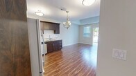 Located at 570 Park Avenue West in Chatham-Kent, Ontario, this thoughtfully designed one-bedroom, one-bathroom unit offers a comfortable and functional layout finished with modern details throughout. Warm hardwood-style flooring flows consistently across every room, lending a cohesive and inviting character to the entire space.

The kitchen is a standout feature, showcasing rich dark wood cabinetry, granite countertops, a classic white subway tile backsplash, and a full suite of stainless steel appliances including a built-in microwave, electric range, dishwasher, and French door refrigerator. A double stainless steel sink and elegant pendant lighting complete the kitchen's polished look.

The generously sized bedroom offers a tranquil retreat with a large window dressed in vertical blinds that allows natural light to fill the room. It includes a double sliding closet for ample storage. The full bathroom is clean and functional, featuring a soaker tub and shower combination with built-in shelving, granite-topped vanity, and bright, neutral finishes.

A dedicated laundry room houses a full-size washer and dryer beneath white upper cabinetry, adding everyday convenience. Views from the unit look out onto a quiet residential neighbourhood surrounded by mature trees. The space offers a practical yet refined living environment ideal for comfortable single-occupant living.