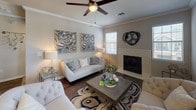 Located at 5270 Bryant Irvin Rd in Fort Worth, Texas, this single-floor residence offers a thoughtfully designed layout with stylish finishes and a warm, neutral color palette throughout. The living room serves as the heart of the home, featuring crown molding, a ceiling fan, a tiled fireplace, and natural light streaming through large windows dressed with wood blinds. The adjacent dining area continues the refined aesthetic with chair rail molding and a window overlooking the exterior. The kitchen is well-equipped with stainless steel appliances, white cabinetry, dark granite countertops, and a decorative tile backsplash, all set atop warm wood-look flooring. Two bedrooms provide comfortable retreats, each with plush carpet, ceiling fans, and natural light from multiple windows. The primary bathroom features white cabinetry with dark granite countertops, a large vanity mirror, a shower-tub combination, and a separate water closet, along with a dedicated linen closet. A second bathroom mirrors the same clean, modern design. Wood-look flooring flows consistently through the main living areas, tying the space together with a cohesive and contemporary feel.
