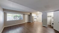 Located at 402 Westover Hills Blvd in Richmond, VA, this single-floor, one-bedroom, one-bathroom unit offers a well-organized layout designed for comfortable everyday living. The living room is the largest area of the unit, featuring rich hardwood-style flooring, neutral gray walls, and a wide window that invites natural light, creating an open and airy atmosphere. The front entry door opens directly into this welcoming space. The galley-style kitchen is efficiently arranged with white upper and lower cabinetry, dark granite-style countertops, a gas range, refrigerator, and a single-basin sink beneath a window overlooking the outdoors. The bedroom is a generously sized retreat, finished with hardwood-style flooring and soft blue-gray walls, with a bright window providing natural light and views of surrounding greenery. Two doors lead from the bedroom — one to the dedicated closet and one connecting to the rest of the unit. The bathroom features a clean, full-size soaking tub with an overhead shower, finished in bright white surrounds. Throughout the unit, consistent flooring and a cohesive neutral color palette create a clean, move-in-ready environment suited for those seeking practical, comfortable living in the Westover Hills neighborhood of Richmond.