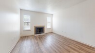 Located at 2420 Riverfront Drive in Little Rock, Arkansas, this 2-bedroom, 1-bathroom residence offers a well-designed single-floor layout that maximizes functionality and comfort. The living room serves as the heart of the home, featuring warm wood-look flooring, a textured ceiling, a tile-surround wood-burning fireplace, and two windows that invite natural light throughout the space. The kitchen is thoughtfully appointed with white shaker cabinetry, granite-style countertops, stainless steel appliances including a dishwasher, electric range, and microwave, along with a peninsula that provides additional prep and dining space. A generous walk-in pantry and in-unit laundry hookups add to the kitchen's practicality. Both bedrooms are carpeted and equipped with ceiling fans for year-round comfort. The primary bedroom includes a dedicated walk-in closet, while the secondary bedroom offers a standard closet and a window with natural light. The full bathroom features wood-look flooring, white cabinetry with granite countertops, and a full tub-shower combination. Throughout the unit, a neutral color palette and clean finishes create a bright, move-in-ready atmosphere well suited for comfortable everyday living.