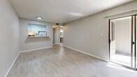 Located at 1311 Louisiana Blvd NE in Albuquerque, New Mexico, this single-story, one-bedroom, one-bathroom residence offers a practical and efficiently designed layout across a compact but well-organized floor plan. Light-toned luxury vinyl plank flooring flows throughout the main living areas and bedroom, complemented by neutral gray walls and textured ceilings that lend a clean, consistent aesthetic throughout.

The combined dining and living area forms the heart of the home, providing an open, versatile space with ample room for both lounging and dining. A pass-through window connects this area to the kitchen, which features white cabinetry, a countertop sink, and tile flooring — offering a functional workspace with a connected feel to the main living space. A hallway leads to the bedroom and bathroom, with two closets providing convenient storage solutions.

The bedroom is a well-proportioned retreat featuring a window dressed with vertical blinds that allow natural light to filter in while maintaining privacy. The full bathroom is finished with stone-look tile flooring, tile wainscoting, a pedestal sink, and a full tub/shower combination. Completing the unit, a private patio extends the living space outdoors, adding a welcome touch of fresh air and outdoor access.