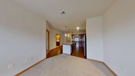 This 620 square foot apartment offers a thoughtful layout with two bedrooms and one bathroom. The kitchen is a standout feature, boasting wood cabinetry, stainless steel appliances, and granite countertops. Track lighting adds a modern touch, while the open design allows for easy interaction with the living area.

The bathroom is efficiently designed with a tub/shower combination and necessary accessibility features. In-unit laundry facilities include a washer and dryer, enhancing convenience for residents. Both bedrooms are carpeted, with one room featuring a large window that provides natural light and a view of the surrounding area.

Throughout the apartment, vibrant yellow accents – particularly noticeable on doors – add a cheerful pop of color to the neutral palette. The mix of flooring types, including tile, hardwood, and carpet, delineates different living spaces while maintaining a cohesive look.

At 130 square feet, the primary bedroom offers ample space. The overall design prioritizes functionality in a compact footprint, making efficient use of the available 620 square feet. Located at 50Twenty on Pendleton Drive in Madison, WI, this single-floor apartment combines modern amenities with a practical layout, suitable for those seeking a contemporary living space.