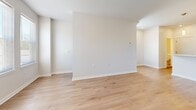 Located at 2275 E 89th St in Cleveland, Ohio, this multi-floor residence offers two bedrooms, one bathroom, and a well-planned layout spread across three levels. The main living floor features an open-concept kitchen and living room finished with light hardwood flooring. The kitchen stands out with rich dark espresso cabinetry, white countertops, a peninsula with pendant lighting, and a full suite of stainless steel appliances including a refrigerator, range, and built-in microwave. Recessed lighting adds a clean, modern touch overhead. The living area benefits from multiple windows that invite generous natural light and views of the surrounding neighborhood. A wall-mounted mini-split system provides efficient climate control throughout. The upper floor houses both bedrooms, each carpeted for comfort. The spacious primary bedroom features a ceiling fan with light fixture, a double-door closet, and large windows that brighten the room. The second bedroom is similarly well-lit with ample natural light. The shared full bathroom is finished with tile flooring and includes a tub/shower combo with white tile surround. Two staircases connect the floors, and a dedicated closet provides additional storage. Clean white walls and consistent finishes throughout give the residence a fresh, move-in-ready feel.