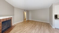 Located at 4729 Manzanita Ave in Carmichael, CA, this single-floor unit offers three bedrooms and two bathrooms within a well-organized layout. Light wood-look flooring runs throughout the home, complemented by neutral warm-beige walls and textured ceilings that create a cohesive, clean aesthetic.

The living room serves as the heart of the home, featuring a tile-surround fireplace and a sliding glass door that fills the space with natural light and provides access to an outdoor patio area. The galley-style kitchen is efficiently designed with white cabinetry, granite-style countertops, a stainless steel sink, and black appliances including an electric range and refrigerator.

Each of the three bedrooms features wood-look flooring, neutral walls, and sliding closet doors for built-in storage. The spacious primary bedroom offers generous square footage. Bedrooms are well-lit, with some featuring windows fitted with horizontal blinds.

Both bathrooms include a tub-shower combination with a curved curtain rod, and the full bathroom features a granite-style vanity countertop with an undermount sink and wood-look flooring. A hallway connects the bedrooms and bathrooms, keeping the layout organized and functional throughout.