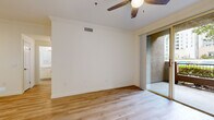 Located at 2242 Gill Village Way in San Diego, CA, this one-bedroom, one-bathroom residence offers a well-organized, single-floor layout designed for comfortable living. Light wood-look flooring runs throughout the home, creating a cohesive and clean aesthetic in every room.

The living room is bright and airy, featuring crown molding, a ceiling fan, and sliding glass doors that open onto a private balcony with outdoor views. The adjacent kitchen is thoughtfully designed with white shaker cabinetry, light stone countertops, a peninsula with an integrated sink, and a full suite of stainless steel appliances including a range, microwave, dishwasher, and refrigerator.

The bedroom is a well-proportioned retreat, equipped with its own ceiling fan, a window with blinds that allow for natural light, and access to a walk-in closet outfitted with dual wire shelving systems for organized storage. The bathroom includes a full tub-shower combination with chrome fixtures and a clean, white tile surround. A hallway connects the private areas of the home, contributing to an efficient and functional flow throughout the space. The overall ambiance is fresh, modern, and move-in ready.